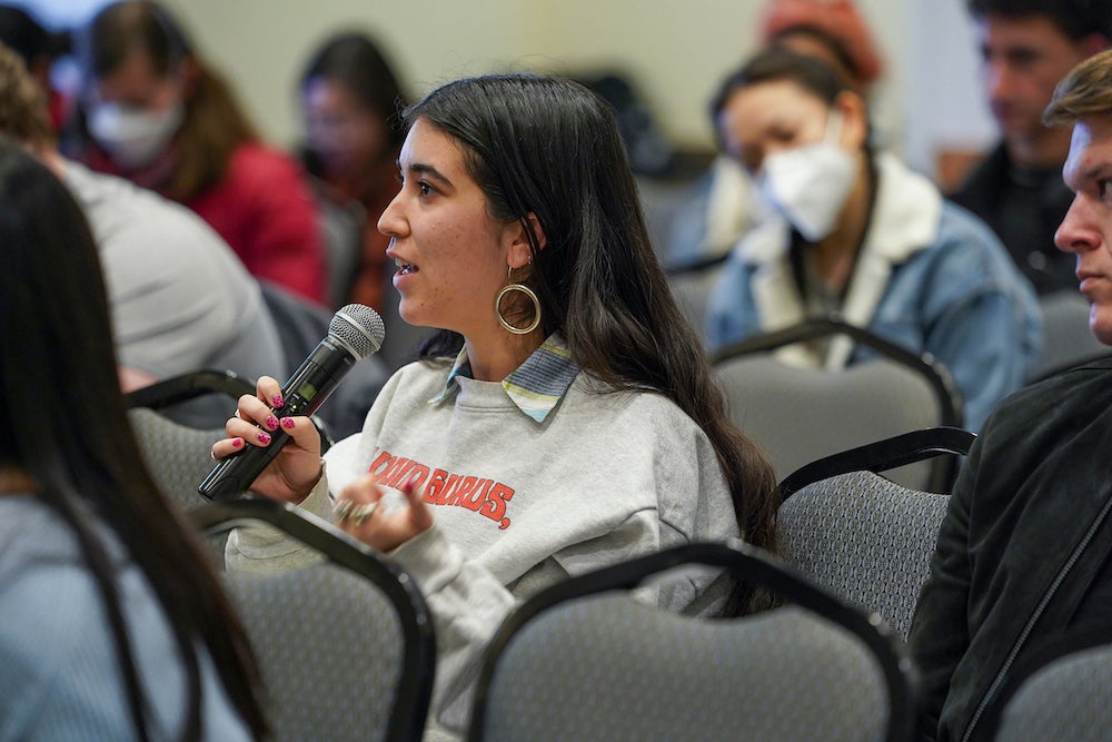 A political science major asks a question at an open forum.